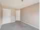 Bedroom showcasing multiple white doors, neutral walls, and plush gray carpeting at 2426 Windridge Dr, Conyers, GA 30013