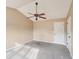 Bedroom featuring neutral walls, vaulted ceiling with fan, and plush carpeting at 2426 Windridge Dr, Conyers, GA 30013
