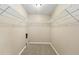 Spacious walk-in closet with wire shelving and carpet flooring ready for organization at 2426 Windridge Dr, Conyers, GA 30013