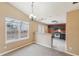 Open dining area flowing into a kitchen with dark cabinets and stainless steel appliances, well-lit space at 2426 Windridge Dr, Conyers, GA 30013