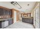 Modern kitchen with stainless steel appliances, dark cabinets, and an open view to the living room at 2426 Windridge Dr, Conyers, GA 30013