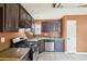 Updated kitchen features stainless steel appliances, dark cabinetry, and tile flooring for modern living at 2426 Windridge Dr, Conyers, GA 30013