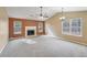 Spacious living room featuring carpet floors, fireplace, and lots of natural light at 2426 Windridge Dr, Conyers, GA 30013