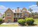 Lovely back exterior showcasing multi-level decks, covered patio, lush lawn, and mature landscaping at 2920 Stanway Ave, Douglasville, GA 30135