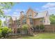 View of the back of the home with multi-level deck and access to fenced backyard at 2920 Stanway Ave, Douglasville, GA 30135