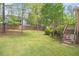 Spacious backyard features lush green grass, mature trees, and access to the deck at 2920 Stanway Ave, Douglasville, GA 30135
