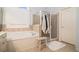 Bathroom featuring a soaking tub and glass enclosed shower at 2920 Stanway Ave, Douglasville, GA 30135