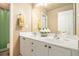 Bathroom featuring double sinks with a large mirror and white cabinets offering plenty of storage at 2920 Stanway Ave, Douglasville, GA 30135