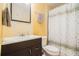 Bathroom features a dark vanity with a white sink, decorative mirror, and shower with patterned curtain at 2920 Stanway Ave, Douglasville, GA 30135
