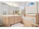 Bathroom features a soaking tub, tile surround, and large vanity at 2920 Stanway Ave, Douglasville, GA 30135