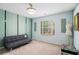 Bright bedroom features a comfortable sofa, large window, and modern ceiling fan with plenty of space at 2920 Stanway Ave, Douglasville, GA 30135