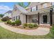 Inviting front porch with black pillars and lush landscaping leading to the front door at 2920 Stanway Ave, Douglasville, GA 30135