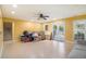 Large living room with tile flooring, ceiling fan, and access to backyard at 2920 Stanway Ave, Douglasville, GA 30135