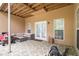 Covered patio features modern outdoor furniture, designer concrete and double doors to the home at 2920 Stanway Ave, Douglasville, GA 30135