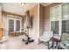 Relaxing porch features comfortable seating, neutral tones, and an outdoor umbrella stand at 2920 Stanway Ave, Douglasville, GA 30135