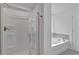 Bathroom featuring a glass-enclosed shower and separate soaking tub at 4140 Chapel Hill Reserve, Douglasville, GA 30135