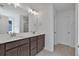 Modern bathroom featuring a double vanity with stylish gray cabinets and a large mirror at 4140 Chapel Hill Reserve, Douglasville, GA 30135
