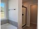 Bathroom featuring a tub, glass enclosed shower, and large window at 4140 Chapel Hill Reserve, Douglasville, GA 30135