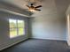Spacious bedroom with plush carpeting, a ceiling fan, and a large window at 4140 Chapel Hill Reserve, Douglasville, GA 30135
