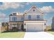 Two-story home featuring gray siding, a two-car garage, and a well-manicured lawn at 4140 Chapel Hill Reserve, Douglasville, GA 30135