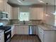 Well-equipped kitchen features white cabinets, stainless steel appliances, and granite countertops at 4140 Chapel Hill Reserve, Douglasville, GA 30135