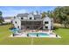 Aerial view showcasing the backyard pool, patio, and well-manicured lawn of this estate home at 445 Roper Rd, Canton, GA 30115