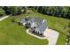 Aerial view of home with manicured lawn and driveway at 445 Roper Rd, Canton, GA 30115
