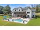 Luxury home exterior with a stunning pool, lounge area and outdoor screened in living space at 445 Roper Rd, Canton, GA 30115