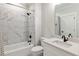 Bright bathroom featuring marble tile, shower over tub, and a modern vanity with black fixtures at 445 Roper Rd, Canton, GA 30115