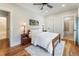 Light bedroom featuring wood floors, ceiling fan and adjoining bathroom at 445 Roper Rd, Canton, GA 30115