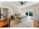 Sun-filled bedroom showcasing a large bed, wood floors, and natural light streaming in from a window at 445 Roper Rd, Canton, GA 30115