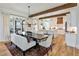 Bright dining area featuring hardwood floors, wooden beam accents and modern chandelier at 445 Roper Rd, Canton, GA 30115
