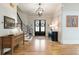 Spacious foyer featuring hardwood floors, a grand staircase, and elegant lighting fixtures at 445 Roper Rd, Canton, GA 30115