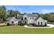 Stunning modern farmhouse with black trimmed windows and doors on an expansive manicured lawn at 445 Roper Rd, Canton, GA 30115
