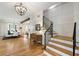 This home's hallway features a wooden staircase, hardwood floors and a view of the dining room and kitchen at 445 Roper Rd, Canton, GA 30115