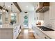 Updated kitchen featuring hardwood floors, custom cabinetry, wooden beam and stainless appliances at 445 Roper Rd, Canton, GA 30115