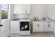Well-lit laundry room with modern washer and dryer, stylish tile flooring and ample storage space at 445 Roper Rd, Canton, GA 30115