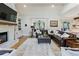 Open-concept living room with a fireplace, hardwood floors, and lots of natural light at 445 Roper Rd, Canton, GA 30115