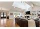 Bright living room with a vaulted ceiling, a brick fireplace, and large windows at 445 Roper Rd, Canton, GA 30115