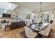 Open living room with fireplace, vaulted ceiling, hardwood floors and comfortable seating at 445 Roper Rd, Canton, GA 30115
