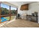Lovely outdoor kitchen with wood countertops, built-in grill, mini fridge and screened in porch views at 445 Roper Rd, Canton, GA 30115