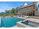 Stunning backyard featuring pool, spa, outdoor lounge area, lush landscaping and screened porch at 445 Roper Rd, Canton, GA 30115