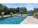 Relaxing backyard oasis featuring inground pool, lounge chairs, lush landscaping, and mature trees at 445 Roper Rd, Canton, GA 30115