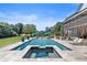 Inviting backyard featuring a pool, spa, lounge chairs, and an expansive manicured lawn at 445 Roper Rd, Canton, GA 30115