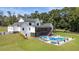 Spacious backyard with a pool, lounge area, and meticulously maintained lawn at 445 Roper Rd, Canton, GA 30115