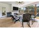 Inviting screened porch with brick fireplace and rustic rocking chairs at 445 Roper Rd, Canton, GA 30115