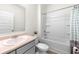 Well-lit bathroom includes a shower-tub combination, neutral walls, and a single sink at 1961 Vidalia Ct, Dacula, GA 30019