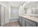 Bright bathroom includes a double sink, soaking tub, neutral walls and frameless shower at 1961 Vidalia Ct, Dacula, GA 30019