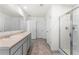 Large bathroom includes a double sink, neutral walls, frameless shower, and plenty of space at 1961 Vidalia Ct, Dacula, GA 30019