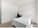 Minimal bedroom featuring neutral walls, carpet, and a simple bed setup at 1961 Vidalia Ct, Dacula, GA 30019